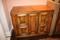 Front view of Pepplar oak wood bar server with paneled cabinet doors, showing overall structure and finish.