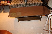 Top view of the rectangular coffee table with glass topper and wood-melamine finish.