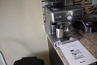 Machine front view on countertop with instruction manual and accessories