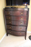 Full frontal view of the Somerton highboy dresser showing the 5 drawers and brass handles. Shows dark wood finish and light surface imperfections.