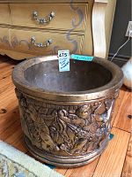 Alabaster plant pot front view highlighting carved cherub and animal figures, with size card and condition visible