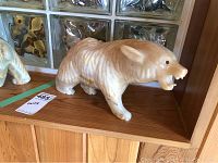 Front angled view of a carved onyx bear sculpture, showing the facial details and polished stone finish