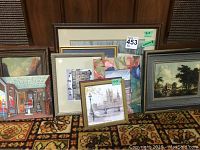 Nine framed prints displayed on a carpet showing their relative sizes and frame designs.
