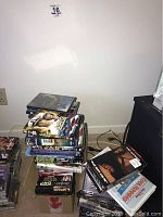 Photo showing large stacks of DVDs including multiple JAG series seasons in standard DVD cases.