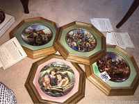 Four wood framed collector plates shown together with certificates