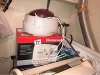 Photo of the Honeywell humidifier resting on top of its original box showing the unit and power cord.