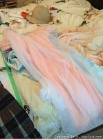 Pink sheer vintage negligee and other garments laid on bed