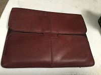 Soft brown leather Targus portfolio folded with flap closure visible.