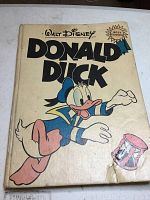 Front cover of Donald Duck hardback comic showing illustrated Donald Duck and signs of wear at bottom corner.