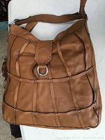 Front view of authentic large Toscani handbag tote in light brown leather with perforations and leather strap design.