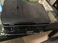 Closed view of Epson Workforce 630 printer showing the top automatic document feeder and front control panel.