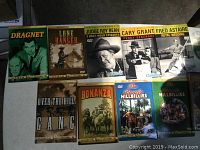 Photo showing the entire DVD bundle including Dragnet, Lone Ranger, Judge Roy Bean, Penny Serenade, Royal Wedding, Over the Hill Gang, Bonanza, and Beverly Hillbillies titles.