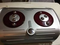 Top view of the Homedics Foot Pleaser foot massager showing two large circular massage heads and power button on a silver casing.