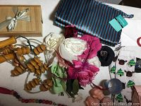 Photo showing handmade ceramic gift box, wooden hand massagers, artificial flowers, flower-shaped soaps, Christmas socks, personal massager case