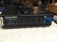 Front view of the PylePro PT 110 PA Amplifier showing input ports, control knobs, and labeling of 80W max output power.