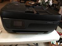 Front and top angled view of HP OfficeJet 3830 showing control panel and automatic document feeder.