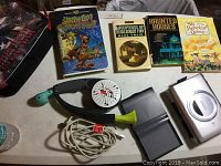 Photo showing the lot contents: Canon CP200 printer, Bop It game, three paperback books, and Scooby Doo VHS.