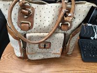 Front view of Stephanie Nicole ostrich-texture purse showing main compartment and front pocket with twist lock closure.