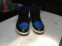 Front view of Retro Nike Air Jordan 1 High OG sneakers in blue and black, size 9.5, showing toe box and laces.