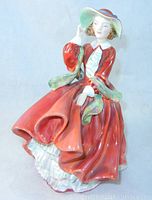 Full view of the Royal Doulton porcelain figurine in flowing red dress with detailed sculpting and glazing.