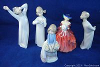 Photo showing all five figurines on blue background.