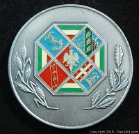 Back side of the medal showing multicolored enamel shield with regional symbols and decorative plants.
