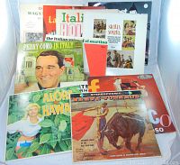 Front view of nine vintage international music LP records showing colorful album covers with Italian, Hawaiian, and Spanish themes.