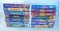 Stack of 14 Disney classic VHS tapes with visible titles including Pinocchio, Pocahontas, Hercules, Mulan, Peter Pan, Sleeping Beauty, Snow White, and others.