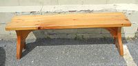 Front view of the handmade wooden pine bench showing length and leg design