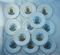 12 Schumann Arzberg salad plates with nautical boat designs arranged showing all three styles.