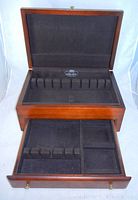 Top view open tip showing slots for flatware inside the mahogany box, lined with black felt.