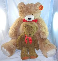 Photo of large 40-inch Vermont Teddy Bear with smaller 20-inch FAO Schwarz Teddy Bear in front