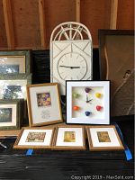 Wide view of wooden framed clock with white clock face and colorful coffee cups as hour markers. Three small 7x7 framed miniature reproductions below the clock.