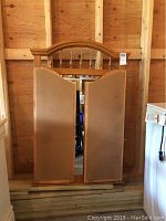 Tri-fold mirror closed, showing the back side and wood frame