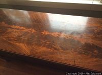 Close-up of the chest top showing wood grain and some surface marks.
