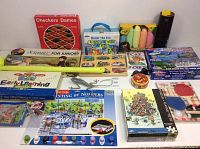Full view of assorted kids games including checkers, puzzles, paint by numbers, art supplies, and table tennis set.