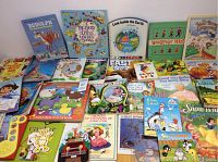 Front overview shot showing the full assortment of children's books including classics, interactive books with puzzle pieces and sound elements, and colorful picture books.