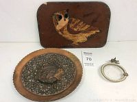 Photo showing the three items: rectangular owl tin, round copper plate with bird, and round ashtray with pearl trim and cherub
