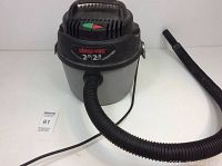 Front view of small portable Shop Vac with hose attached, showing brand label and capacity details.