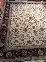 Angled top view showing floral pattern and burgundy border
