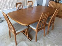 Front-left angle view of table with six chairs.