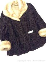 Vintage Persian lamb fur coat showing texture and beige fur collar and cuffs