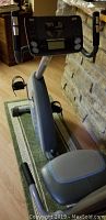 Front view of the stationary exercise bike showing digital monitor and handle grips.