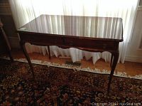 Full front and side view of the wood hall table showing polished wood surface and carved legs.