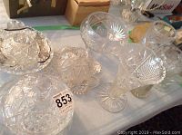 Top view showing multiple cut crystal bowls and part of the decanter and vases, highlighting starburst and geometric cut patterns