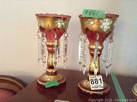 Front view of both candle holders on surface showing overall shape, color and matching set