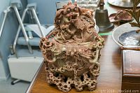 Front view of carved Asian stone jar with lid showing detailed dragon carving and openwork