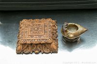 Both Durwood carved box and Asian soapstone bird carving side by side on a dark surface