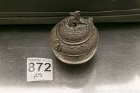 Top-down angled view of the jar highlighting the rabbit-shaped handle on the lid and detailed etching on the metal lid and upper jar body.