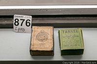 Two original boxes: beige Samson Meter box and green Yankee Battery Tester box side by side.